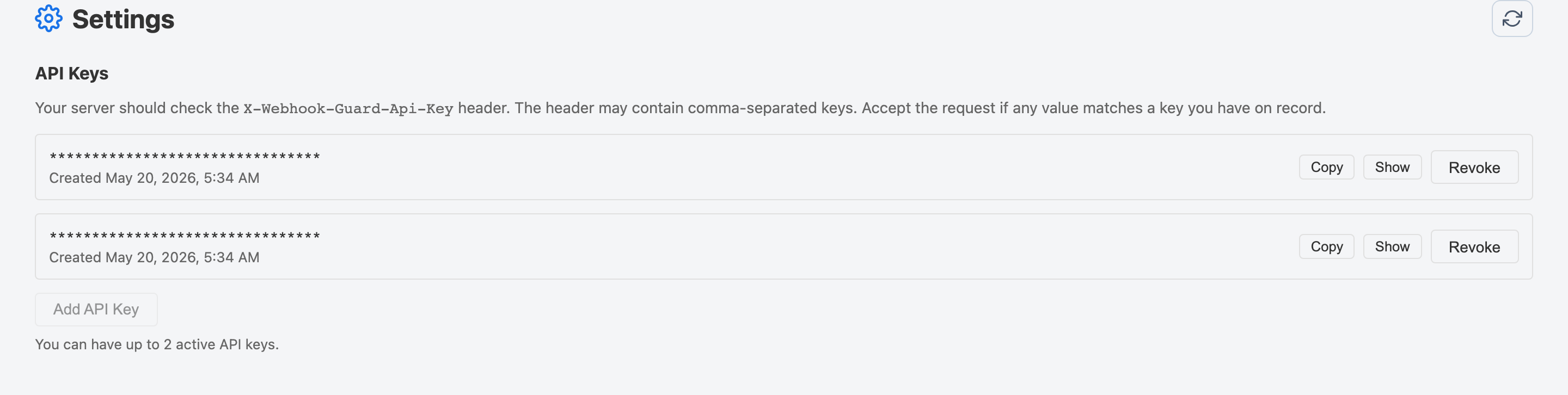 Settings page showing active API keys with Copy, Show, and Revoke actions, the Add API Key option, and a note about the maximum of 2 active keys